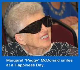 Margaret (Peggy) McDonald smiles at a Happiness Day.